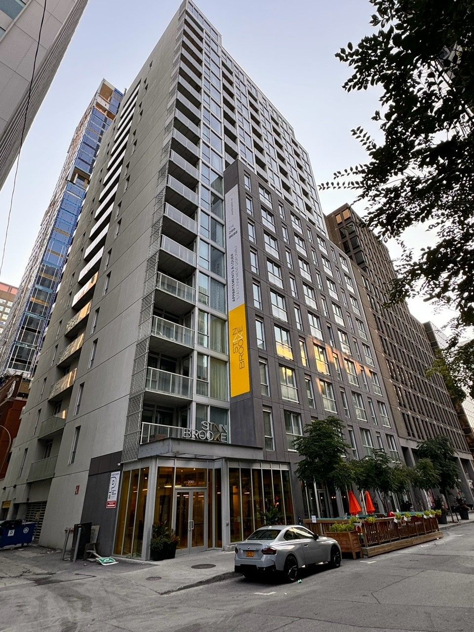 A tall building with a car parked in front of it