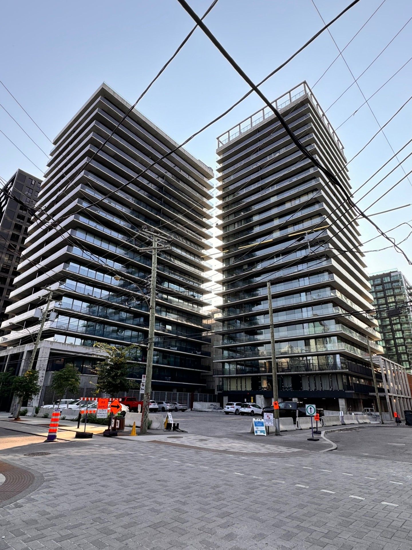 Two tall buildings are sitting next to each other in a city.