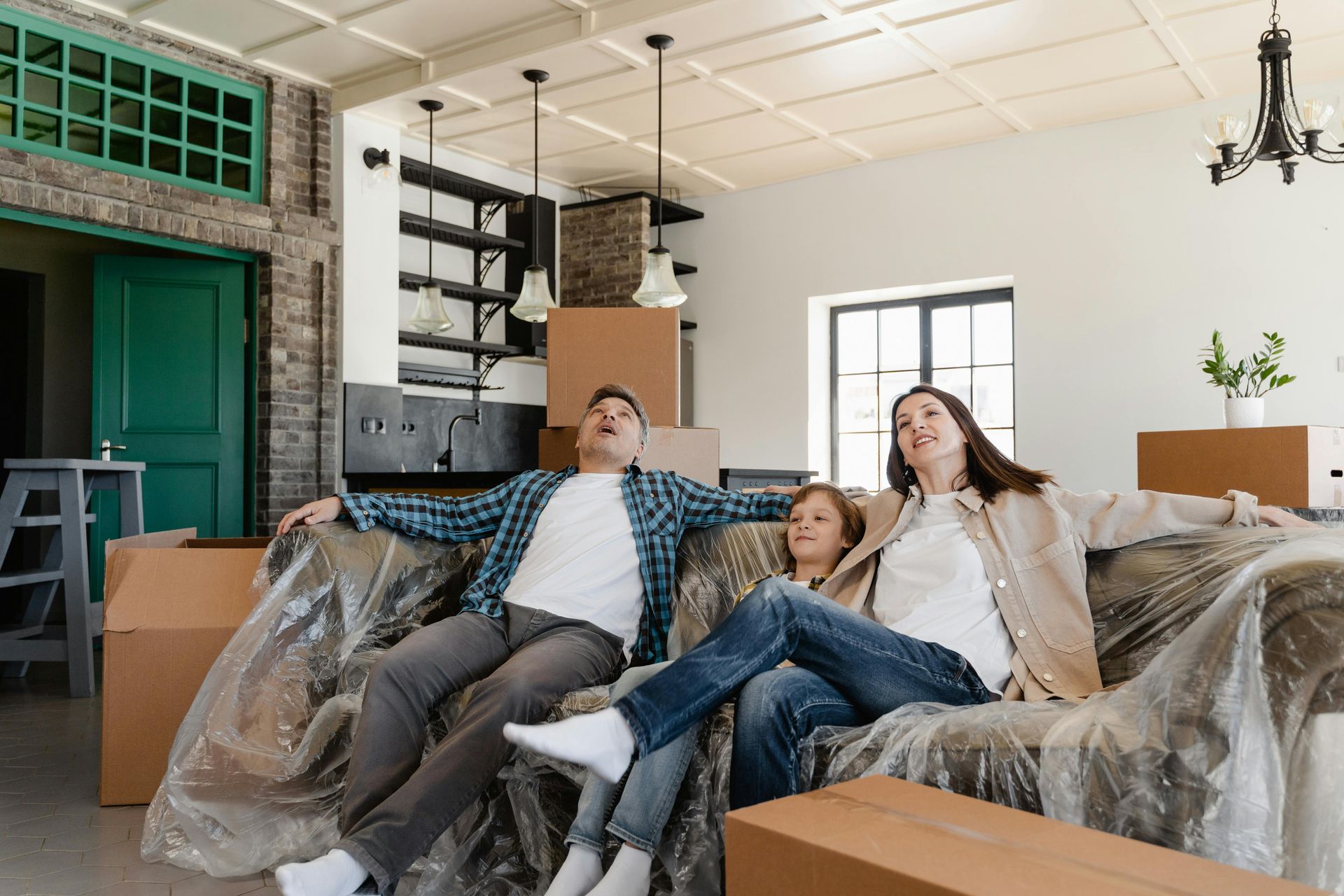 A woman is sleeping in front of two fans.