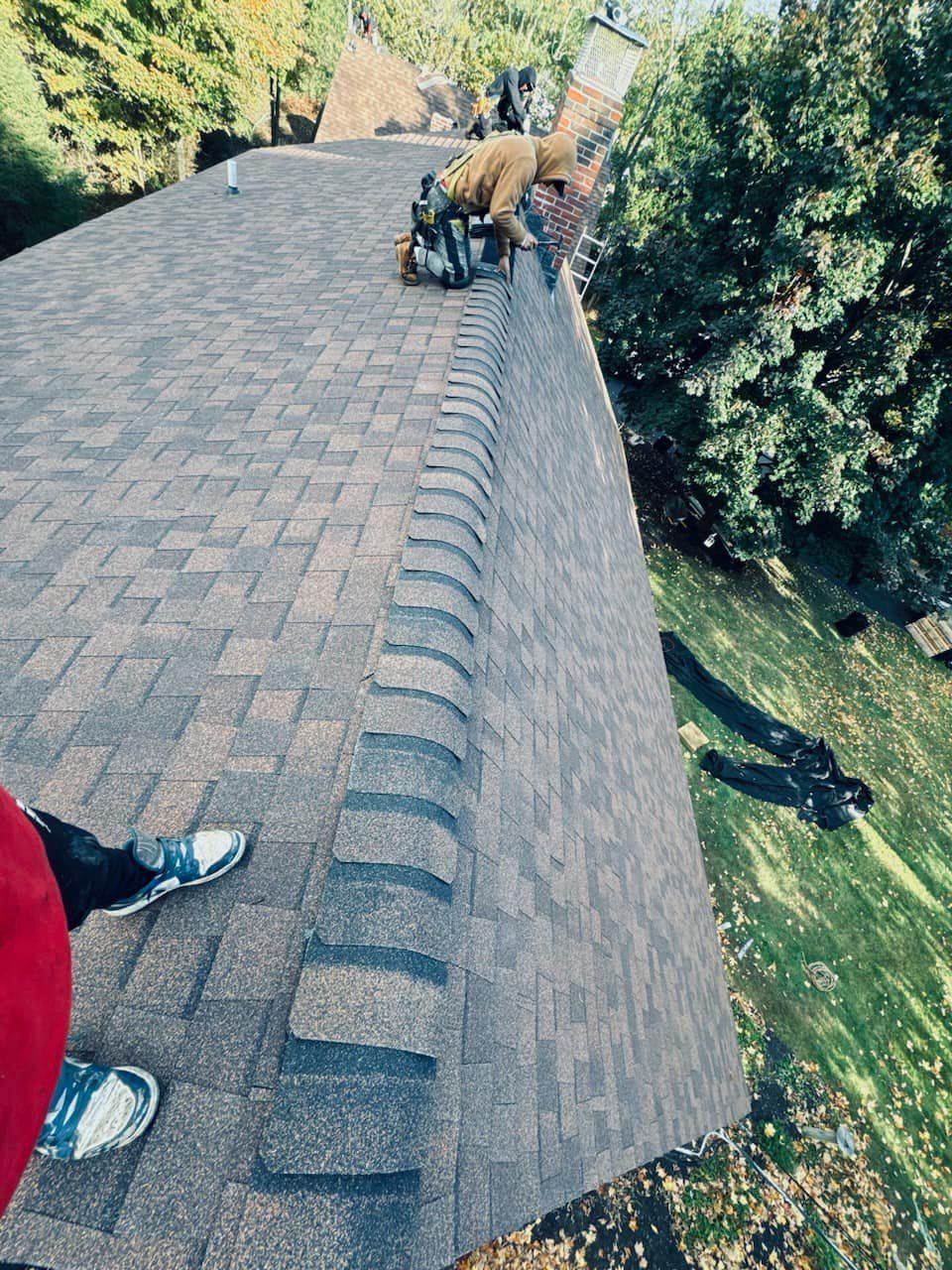 A man is working on the roof of a house.