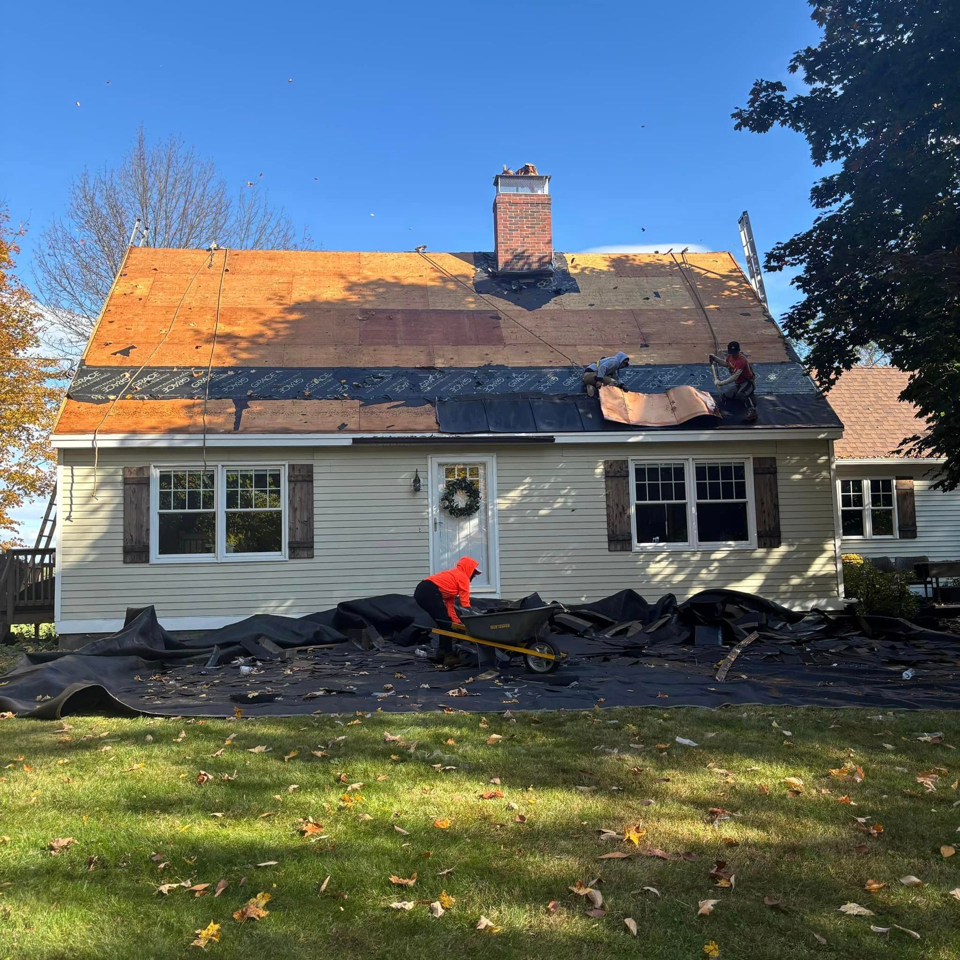 A man is working on the roof of a house