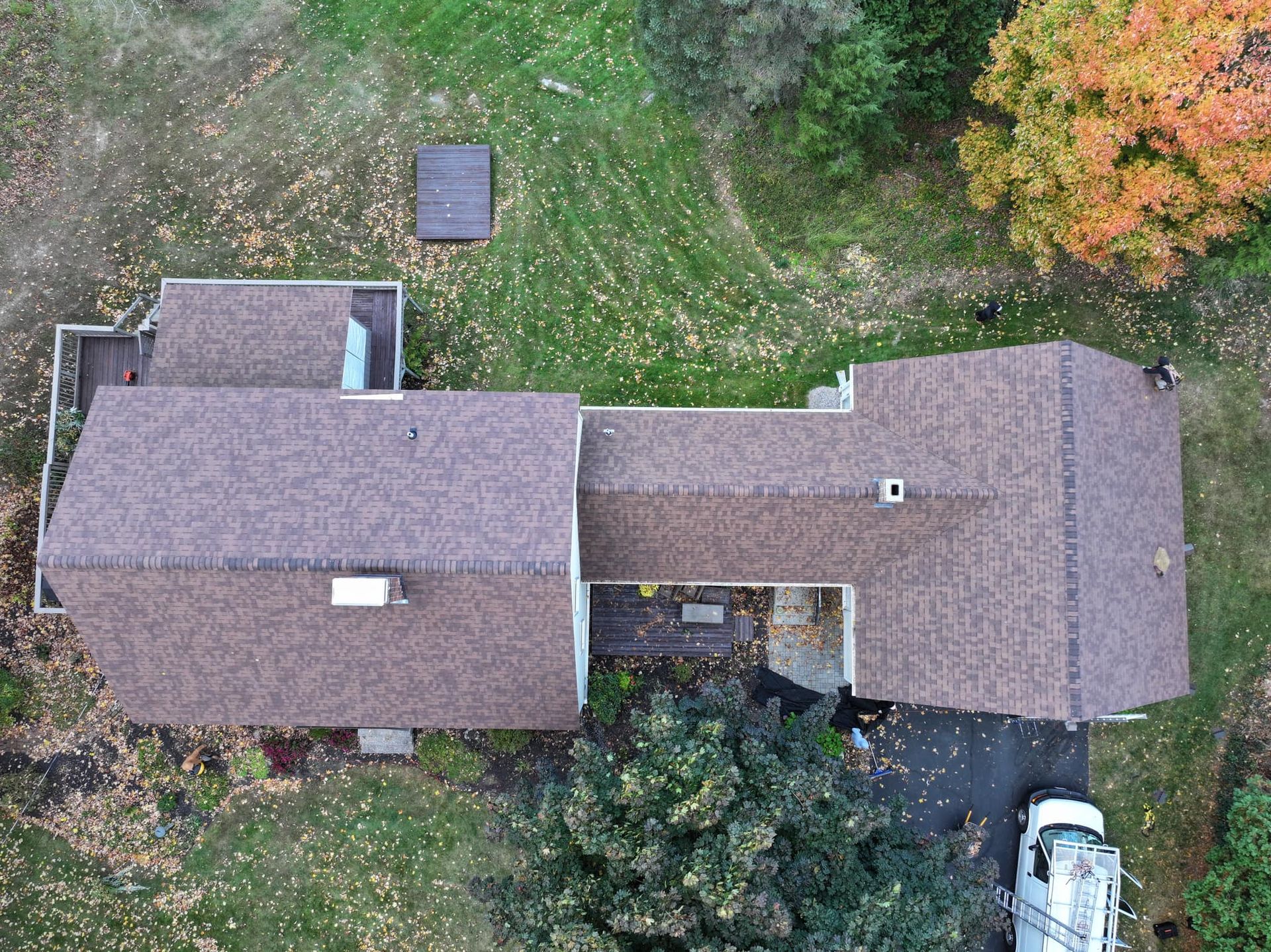 An aerial view of a house with a truck parked in front of it.