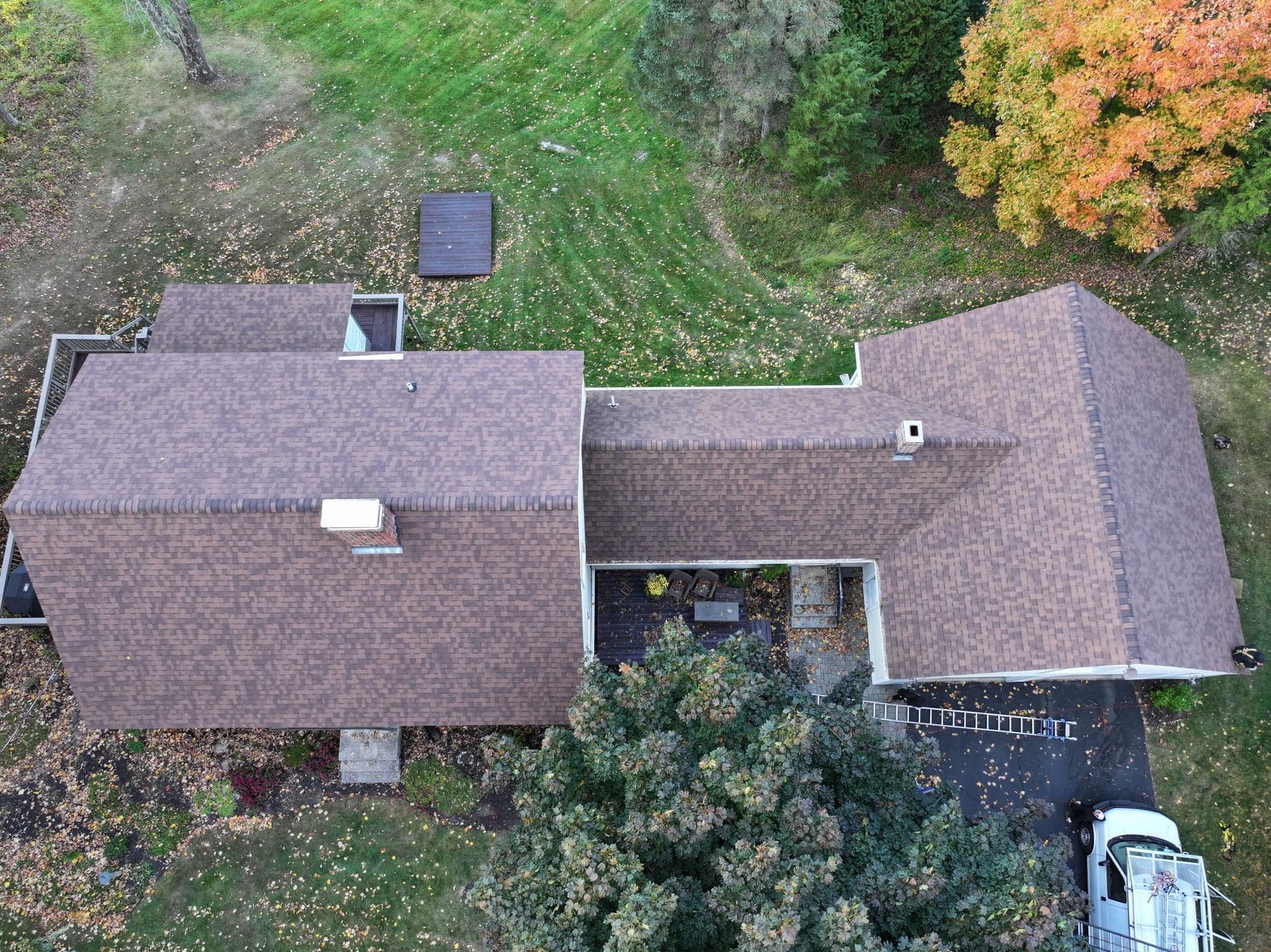An aerial view of a house with a truck parked in front of it.
