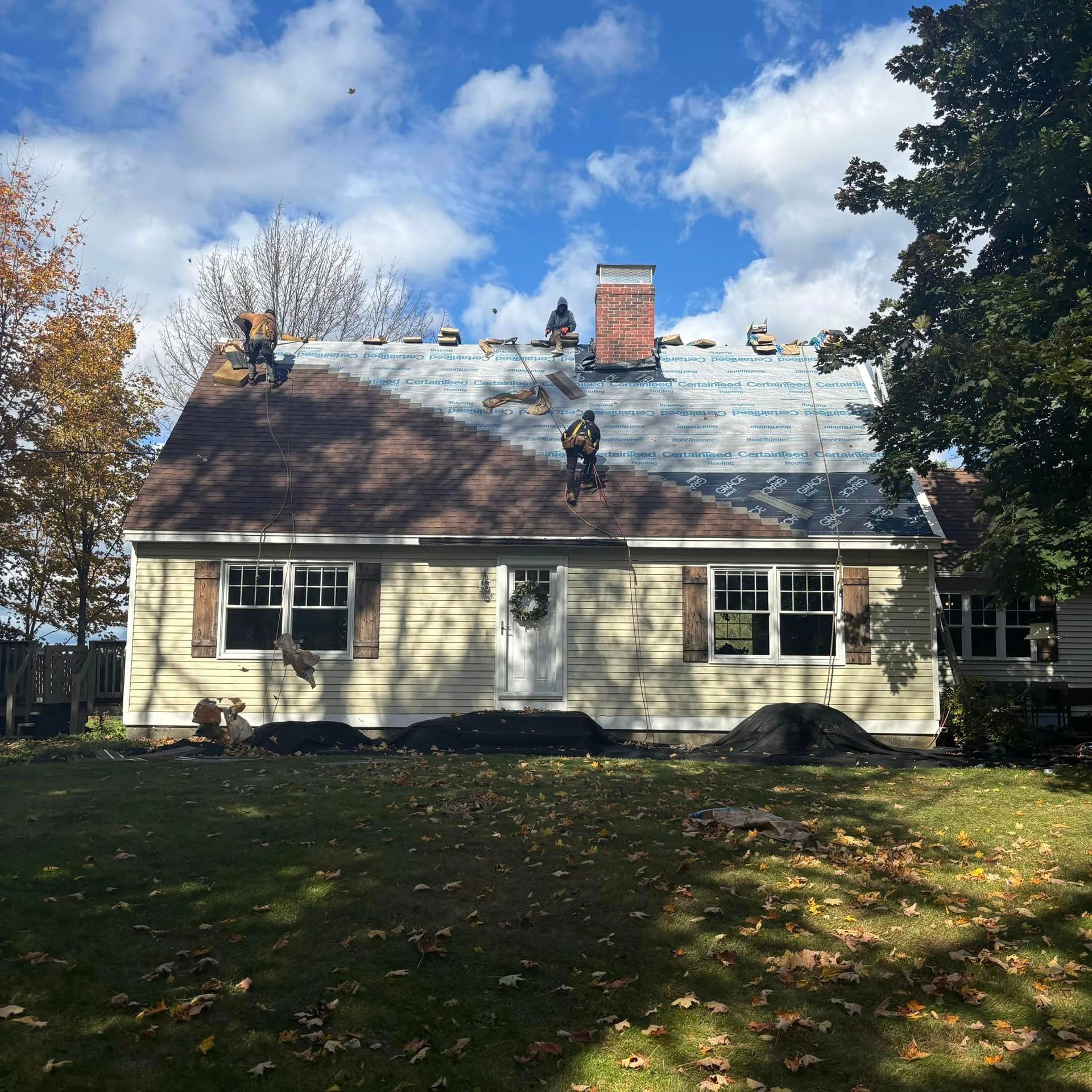The roof of a house is being worked on by two men