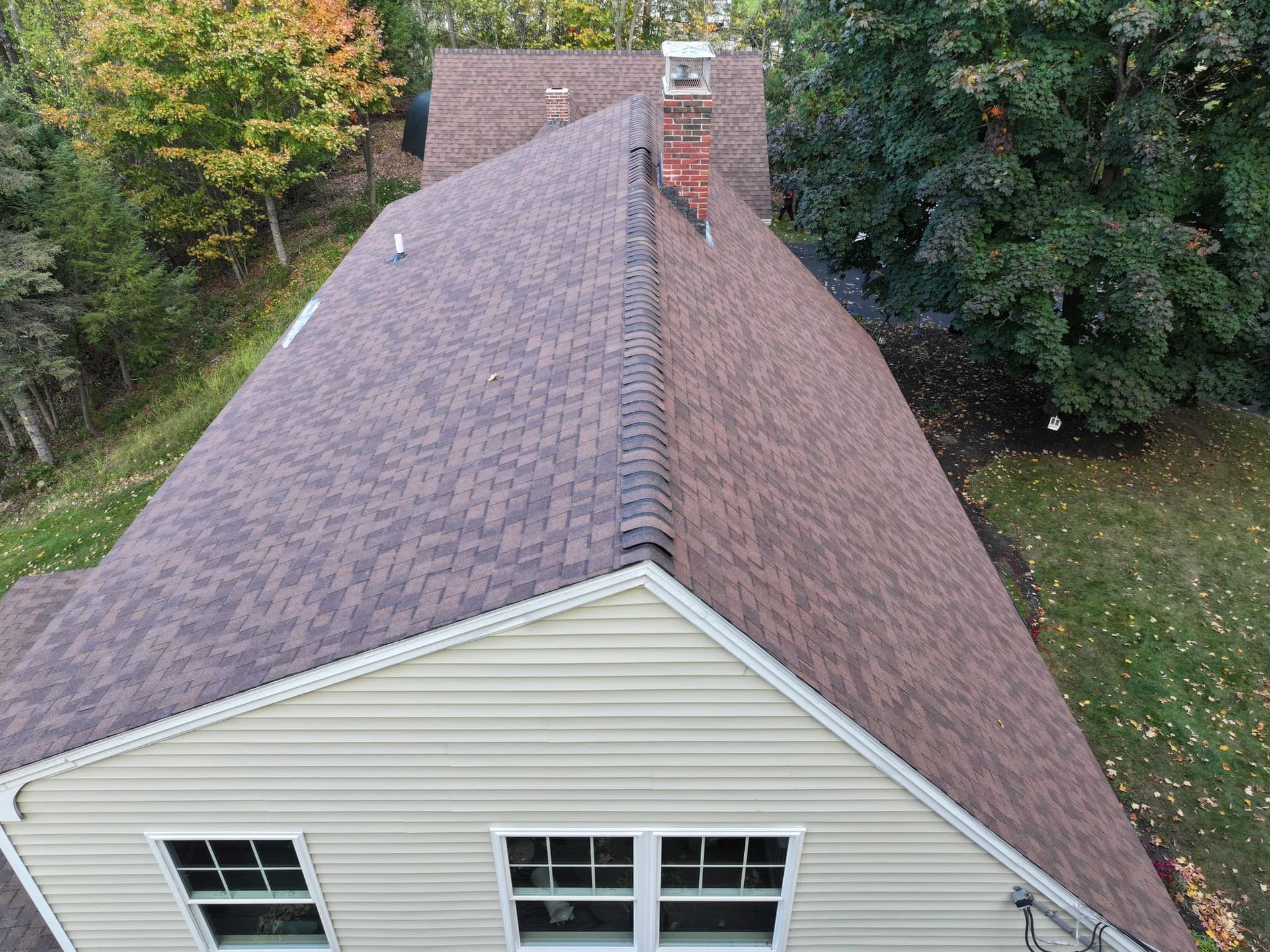 An aerial view of a house with a new roof.