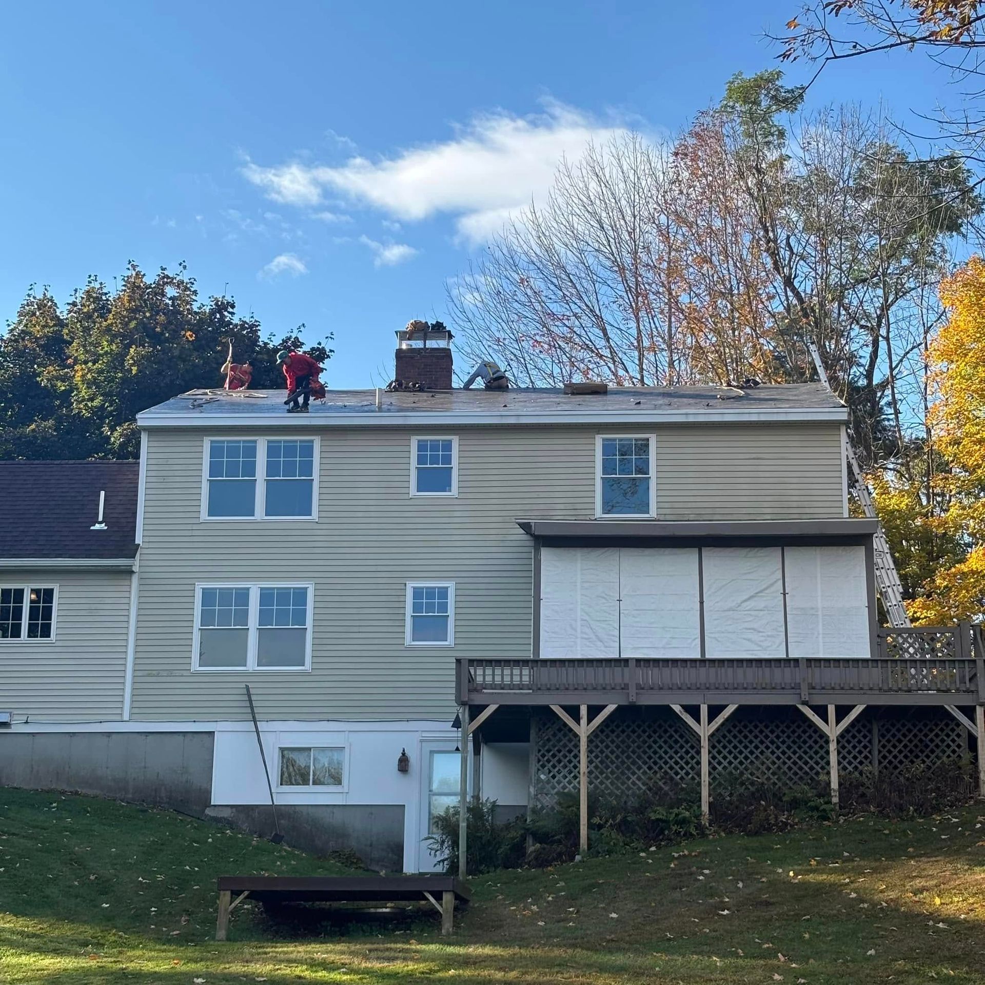 A man is working on the roof of a house