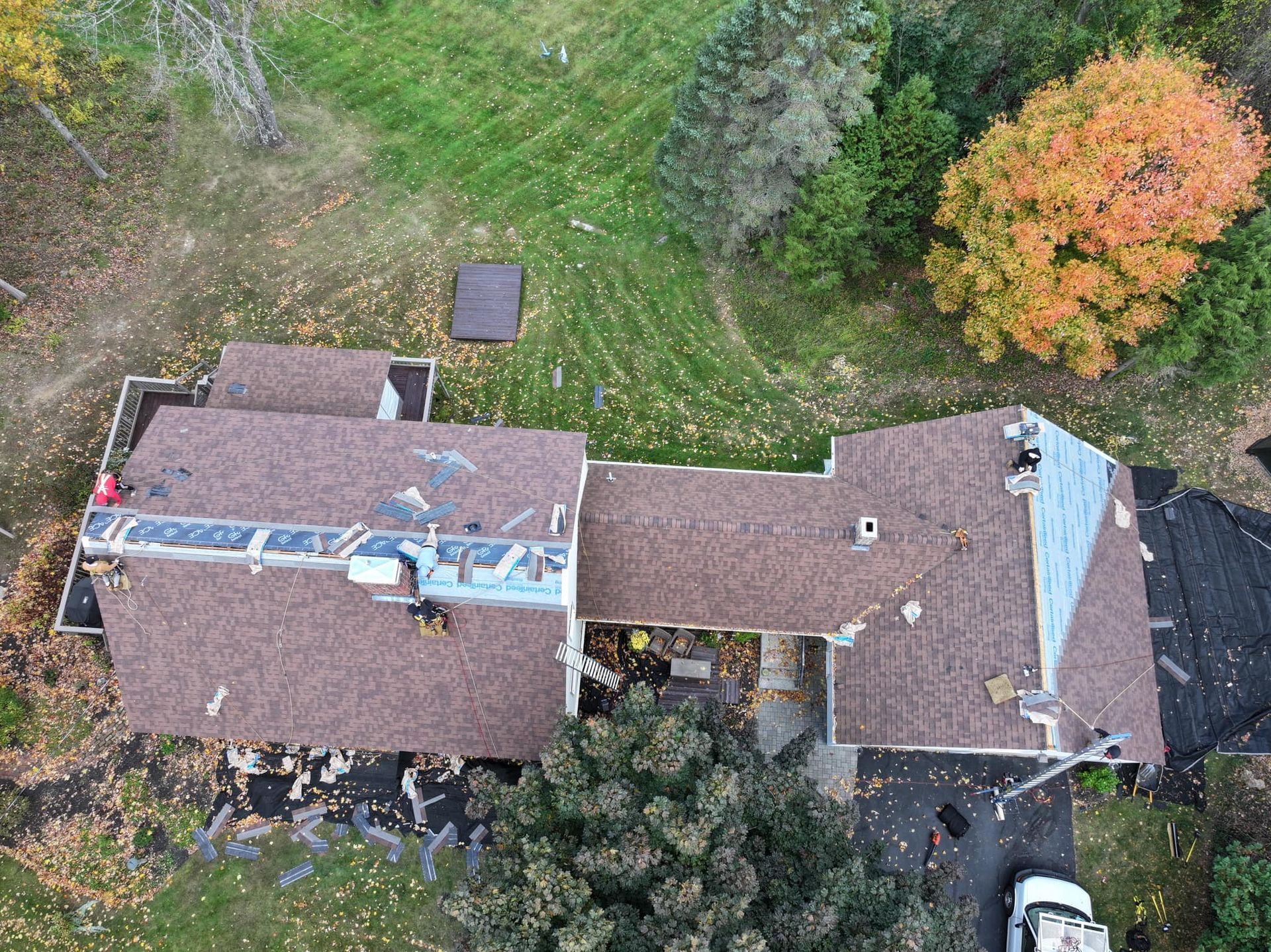 An aerial view of a house undergoing a roof replacement.