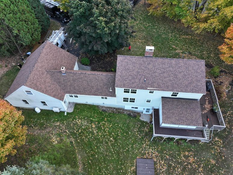 An aerial view of a large house surrounded by trees.