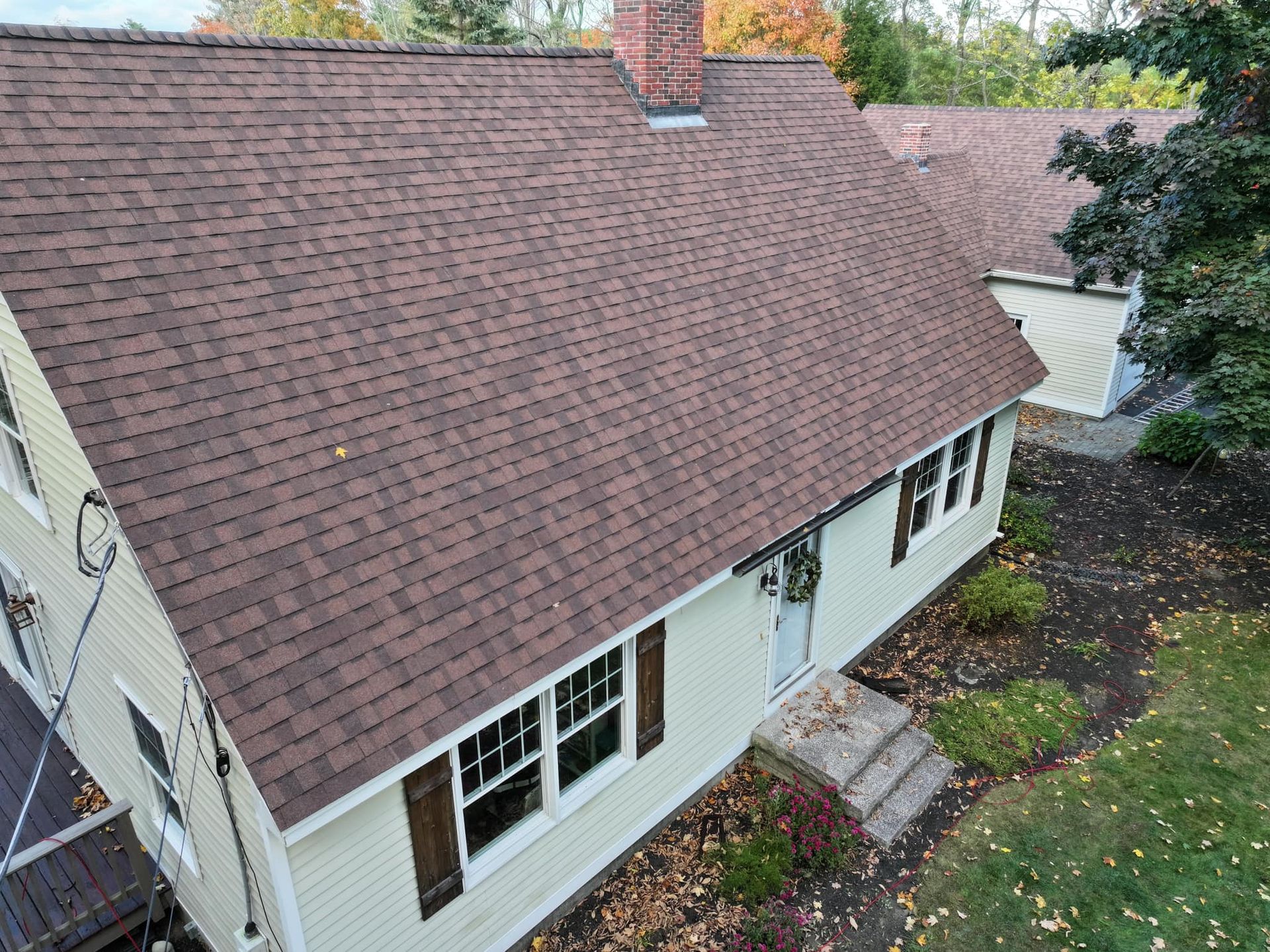 An aerial view of a house with a brown roof.