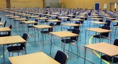 Rows of desks and chiars in an exam hall, before an OMR exam