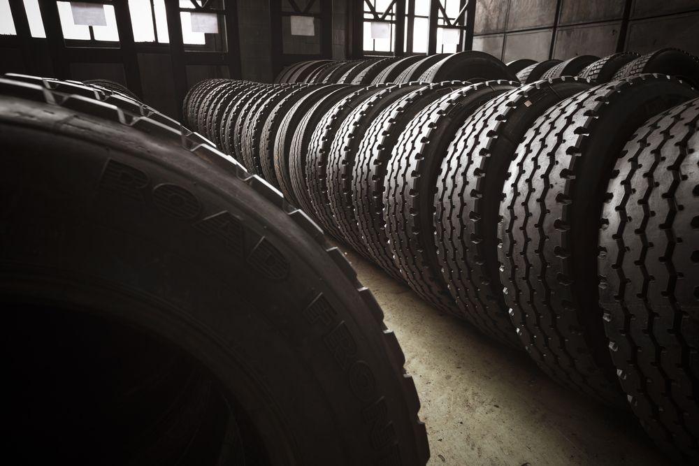 Row of Tires Stacked in a Dimly Lit Warehouse — Ben's Tyres in Narromine, NSW