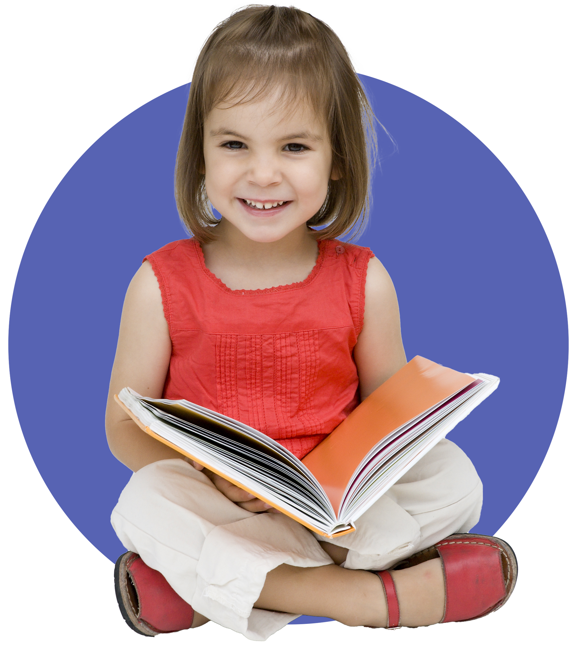 A little girl is sitting on the floor reading a book