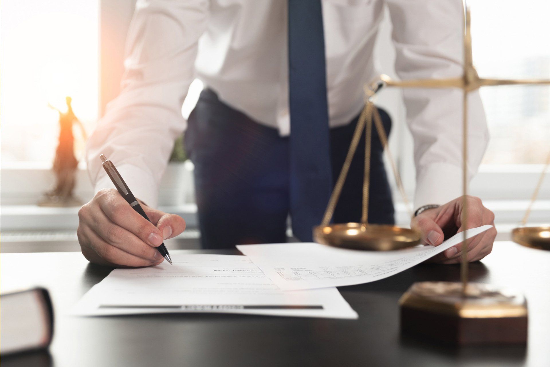 Man Writing In Paper — Houston, TX — Nicholas T. Martinez PLLC Man Writing In Paper — Houston, TX — Nicholas T. Martinez PLLC