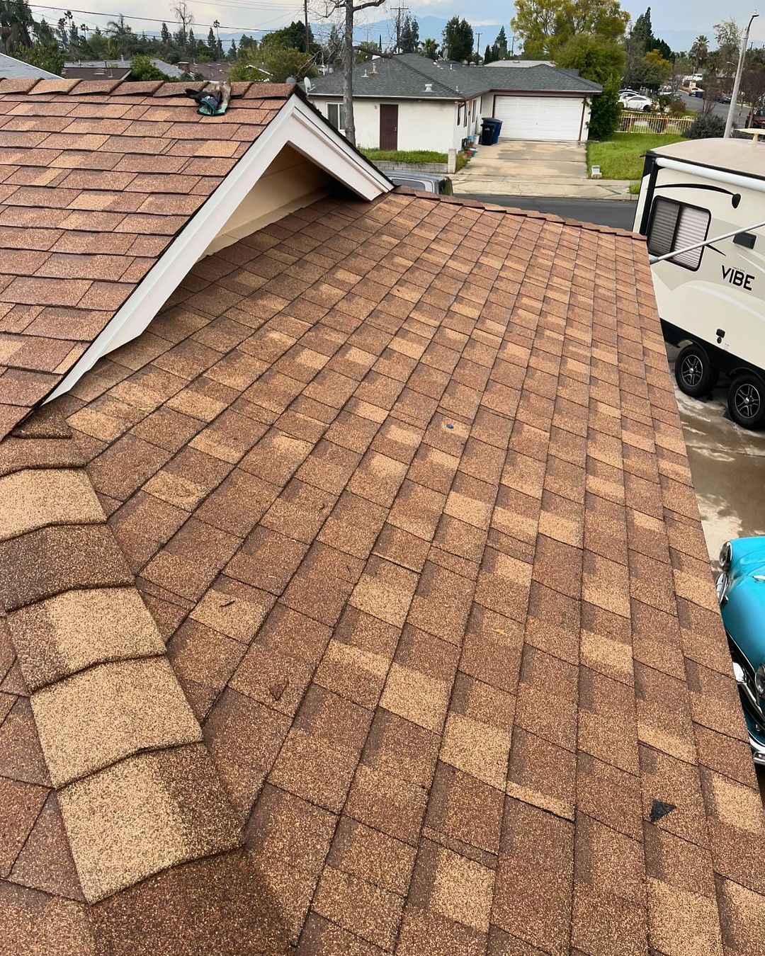 A close up of a roof with a truck parked in front of it.