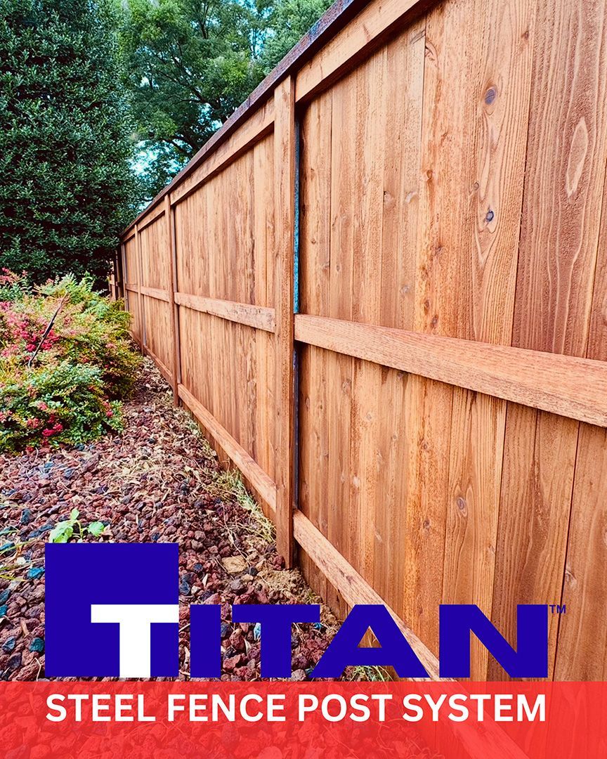 Wooden fence with Titan steel post system; brown planks, foliage in background, logo at bottom.
