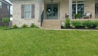 A brick house with a large lawn in front of it – Louisville, KY – Wayne's Lawn Service