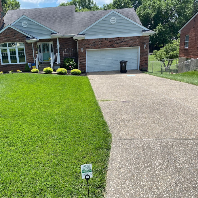 A Brick House with a Driveway Leading to it – Louisville, KY – Wayne's Lawn Service