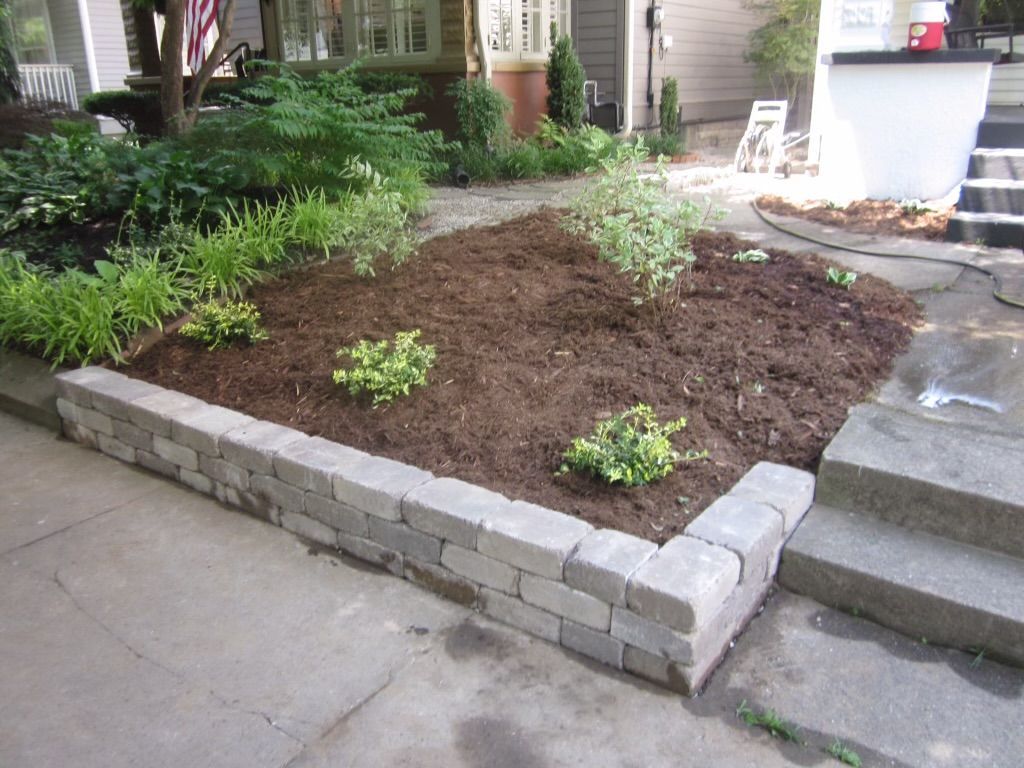 A Garden with a Brick Wall and Steps in Front of a House – Louisville, KY – Wayne's Lawn Service