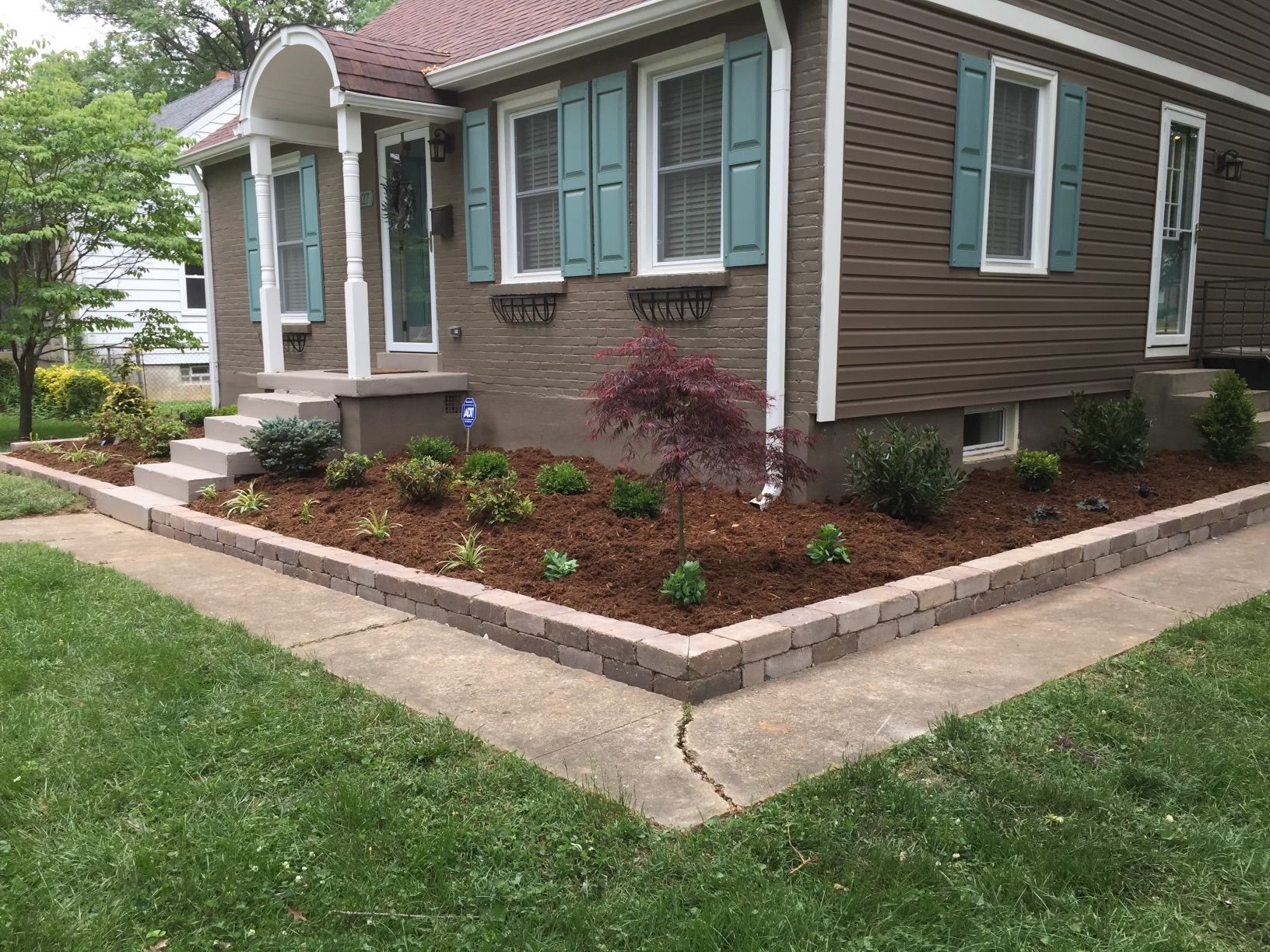 A Brown House with Blue Shutters and a Lush Green Lawn – Louisville, KY – Wayne's Lawn Service