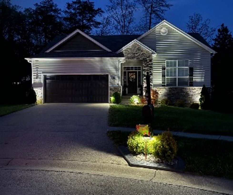 Exterior lighting installation on a home at night. Exterior lighting installation on a home at night.