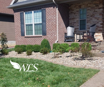 A brick house with a rocking chair in front of it