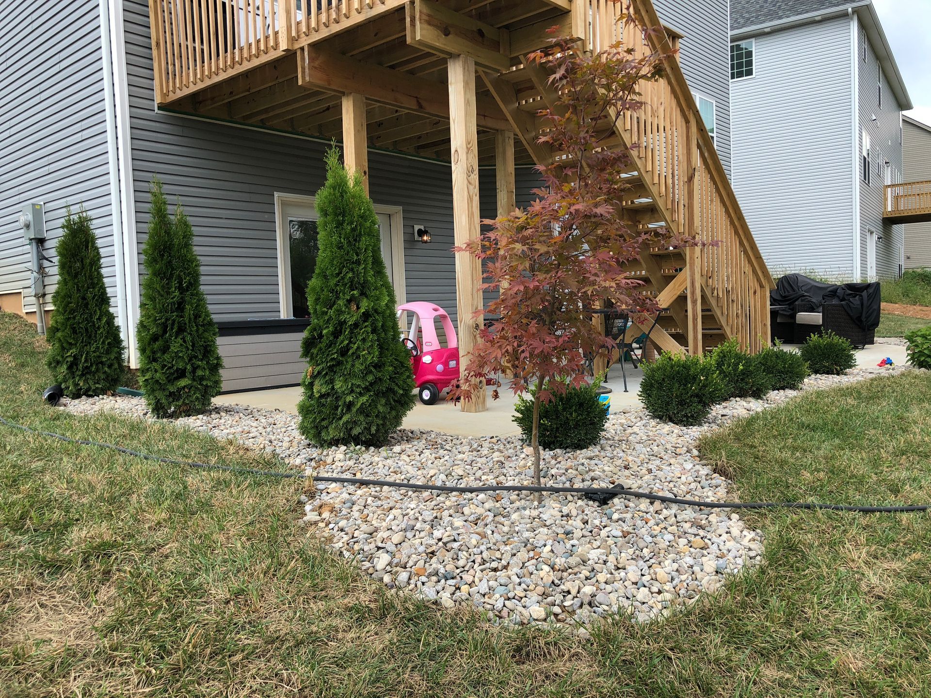 A House with a Deck and Stairs in the Backyard – Louisville, KY – Wayne's Lawn Service