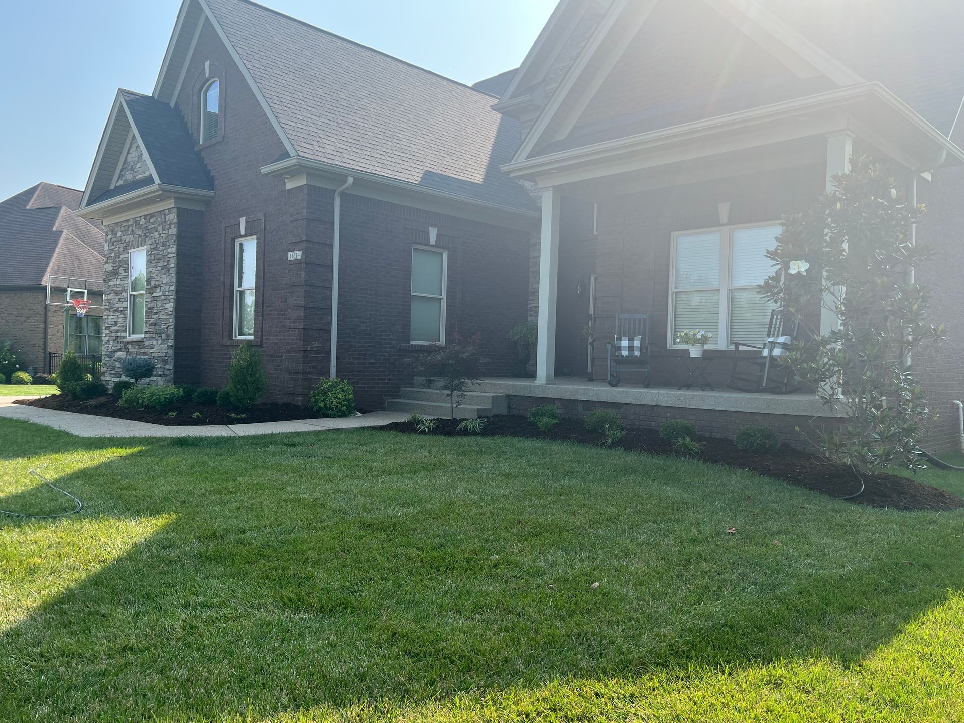 A Large Brick House with a Large Lawn in Front of it – Louisville, KY – Wayne's Lawn Service