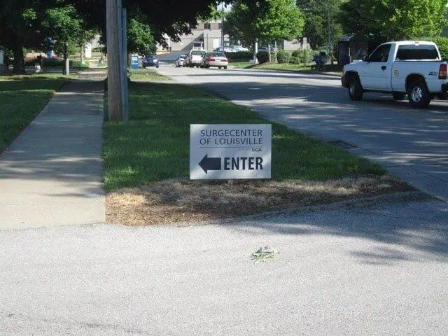 Sign on a grassy verge points left toward 