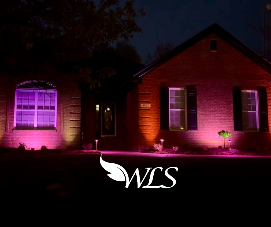 A brick house with purple lights on the windows