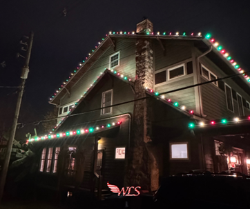 A house decorated with red and green Christmas lights at night. A house decorated with red and green Christmas lights at night.