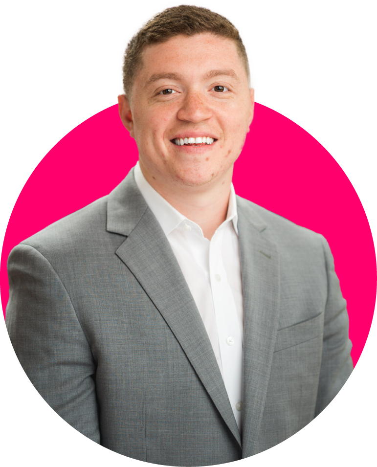 A man in a suit and white shirt is smiling in a pink circle