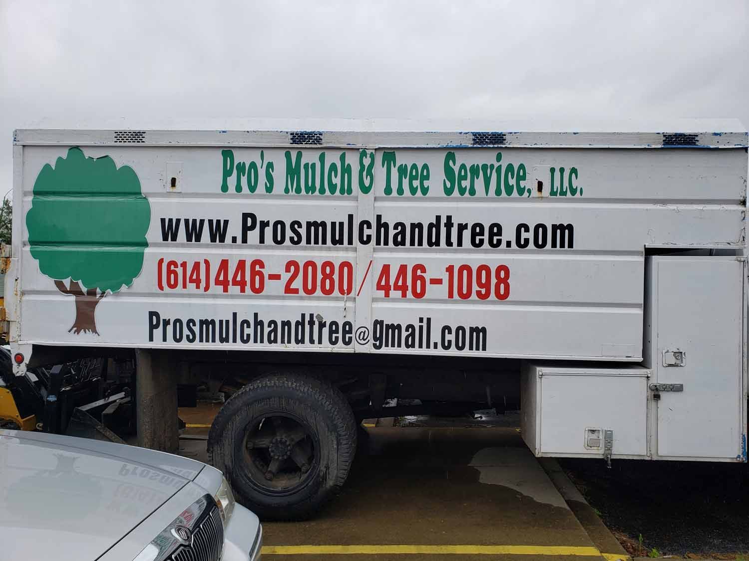 A pro 's mulch & tree service truck is parked in a parking lot