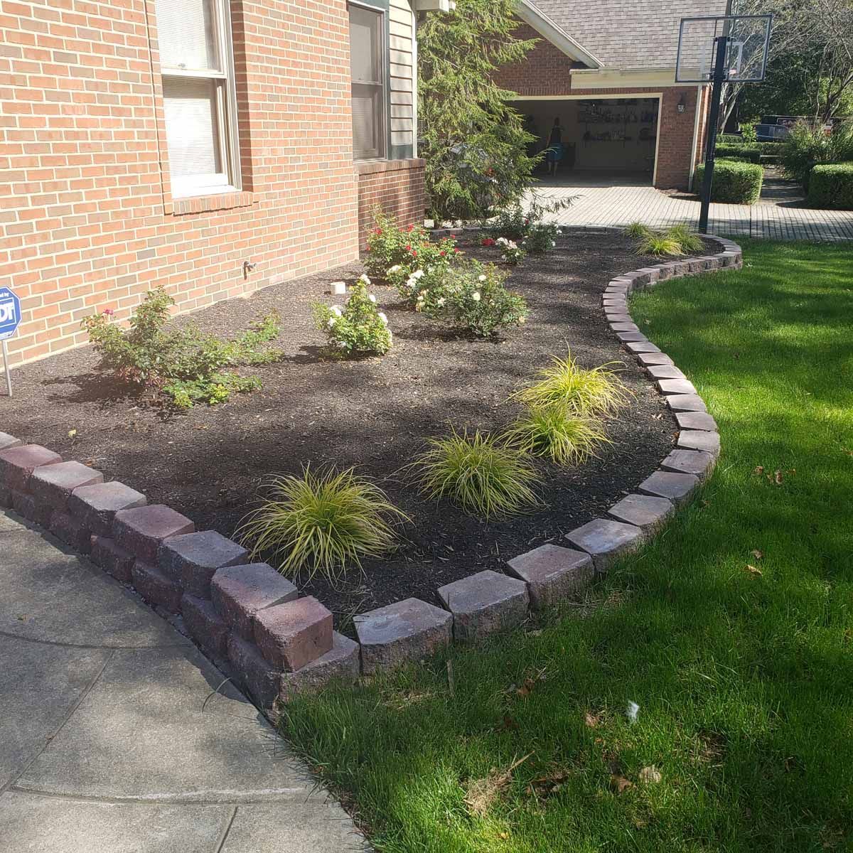 A brick house with a garden in front of it