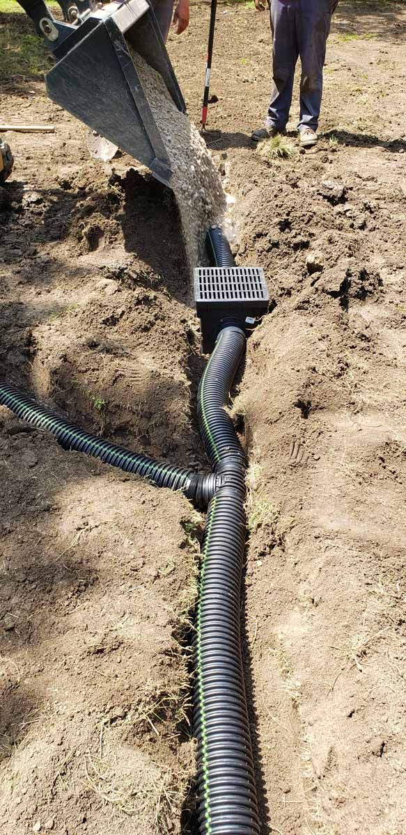 A man is digging a hole in the ground with a shovel.