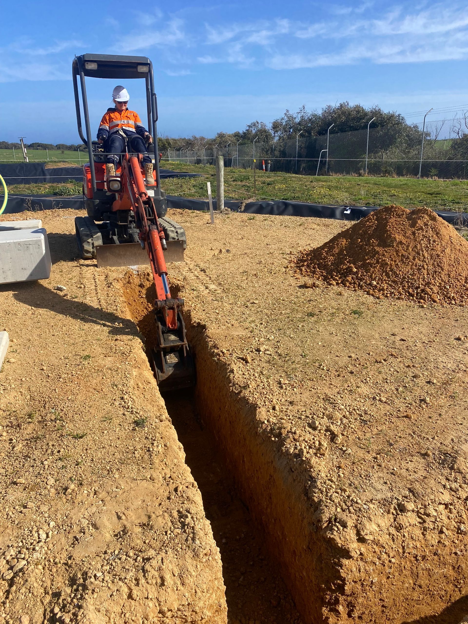 A Man Is Standing Next To A Large White Tank On A Trailer – Warrnambool, VIC - McKinnon Quarries & Civil