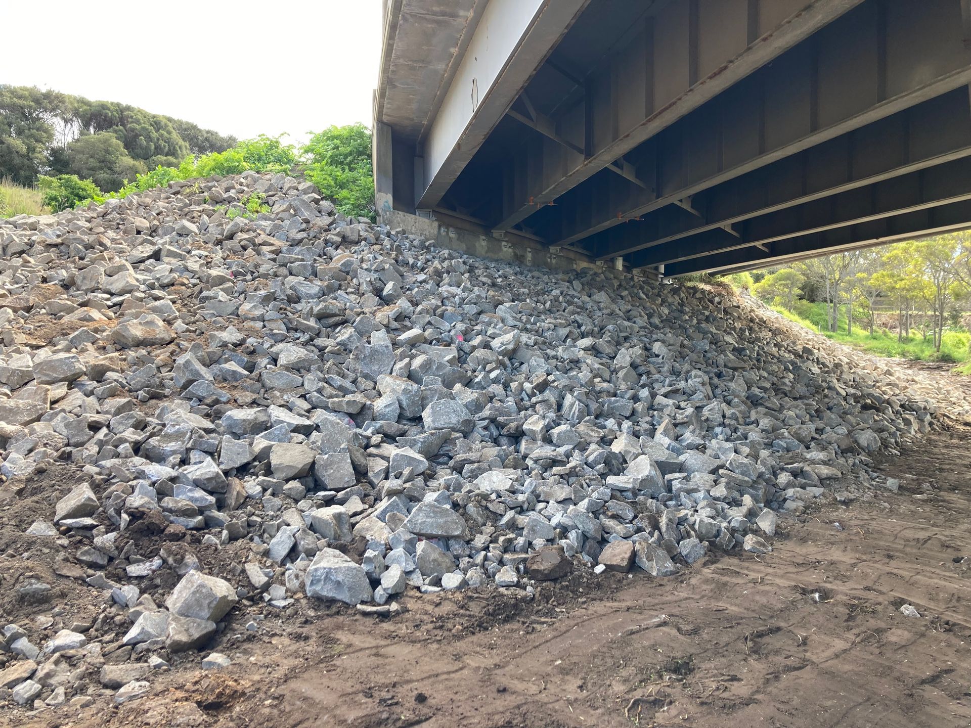 A Concrete Bridge Over A Dirt Road With Trees In The Background – Warrnambool, VIC - McKinnon Quarries & Civil