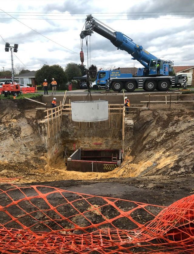 A Crane Is Lifting A Large Piece Of Concrete Into A Hole – Warrnambool, VIC - McKinnon Quarries & Civil