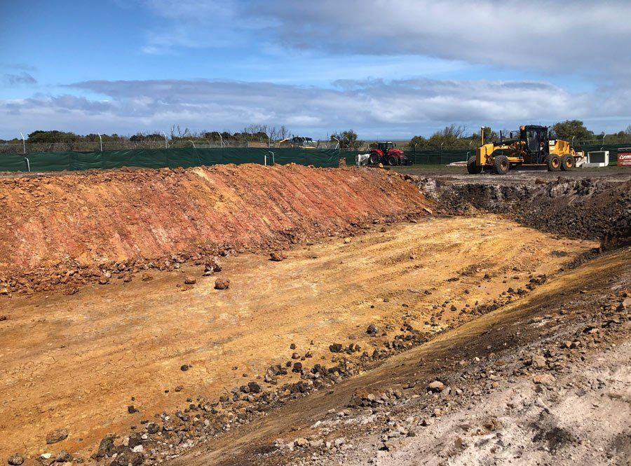 A Construction Site With A Lot Of Dirt And Rocks And A Bulldozer – Warrnambool, VIC - McKinnon Quarries & Civil
