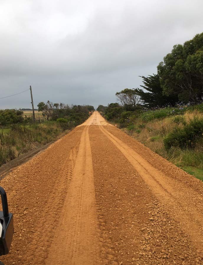 A Dirt Road Going Through A Field With Trees On The Side – Warrnambool, VIC - McKinnon Quarries & Civil