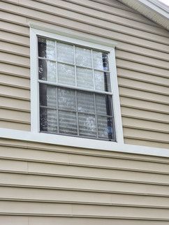 A close up of a window on the side of a house.