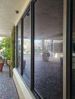 A building with a lot of windows and a brick walkway.