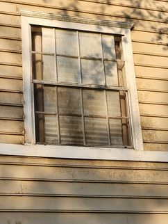 A close up of a window on the side of a house.