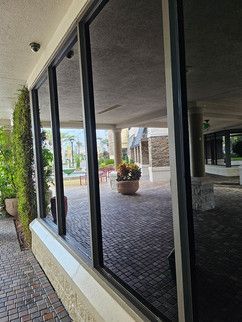 A building with a lot of windows and a brick walkway.