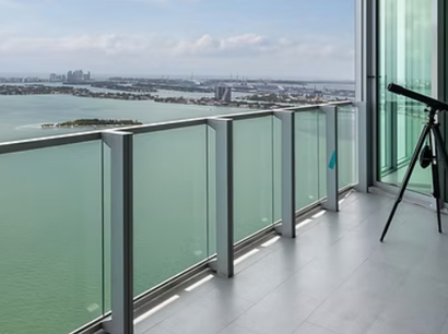 A balcony with a view of the ocean and a telescope.