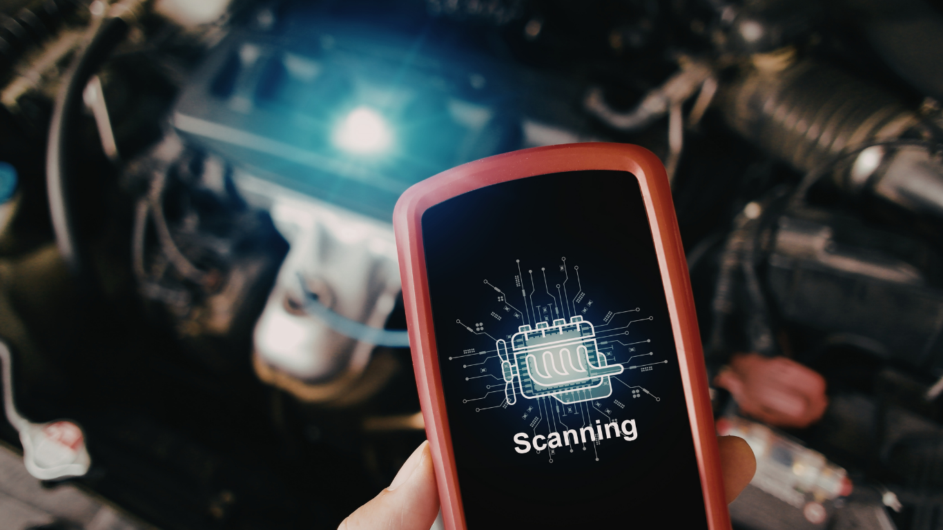 Hand holding a red OBD2 scanner displaying