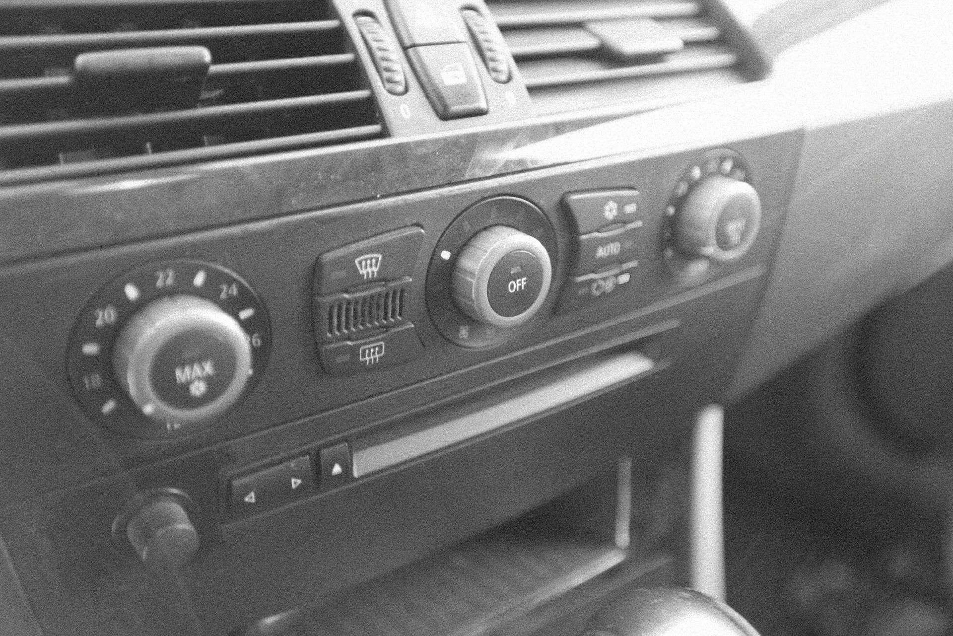Dashboard with climate control knobs and vents.