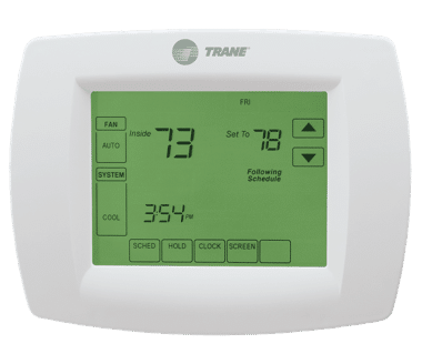 White Trane thermostat with a green backlit