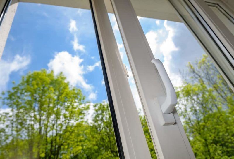 Window with white frame and handle