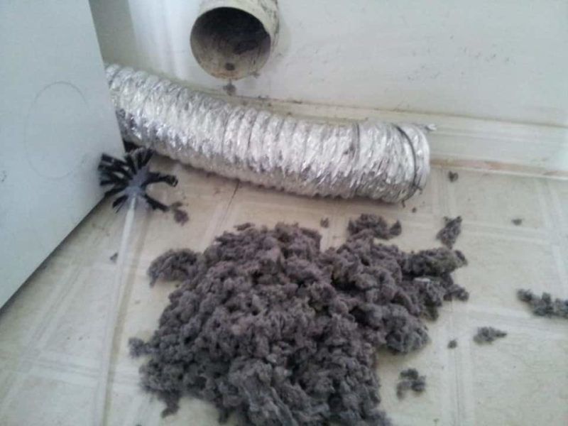Lint pile on floor near dryer vent