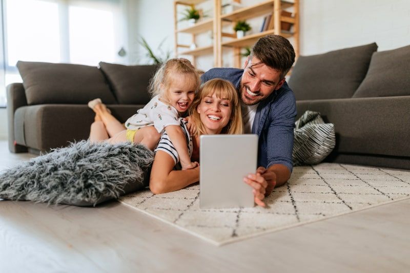 Happy family looking at a tablet together